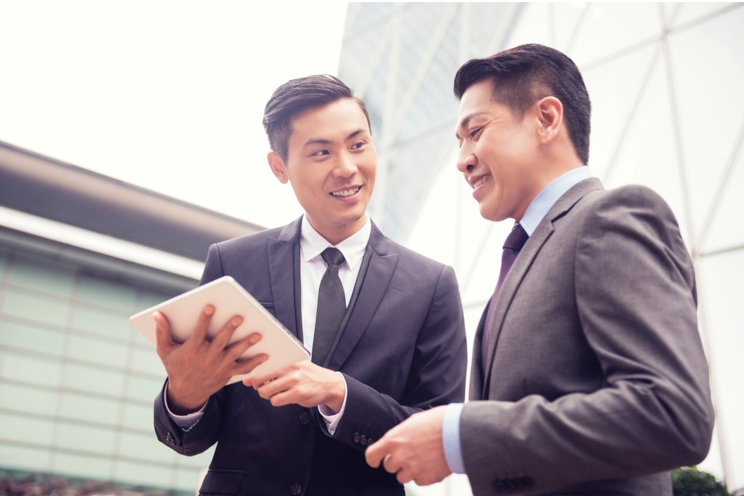 two chinese men discussing on business matching